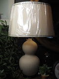Ivory ceramic lamp with oatmeal and black trim shade