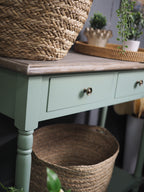 Two drawer green console table with shelf