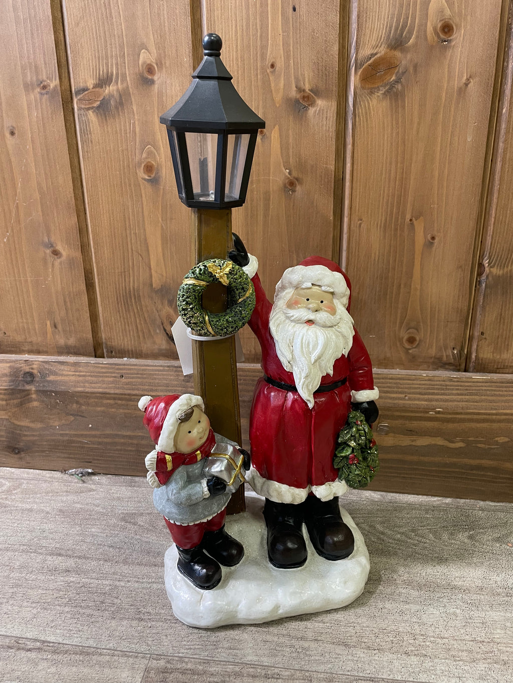 Santa and child with lamp post and wreath