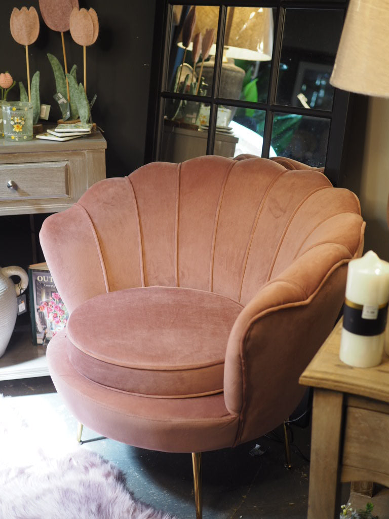 Dusky pink lounge chair with scalloped shell back