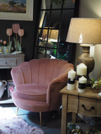 Dusky pink lounge chair with scalloped shell back