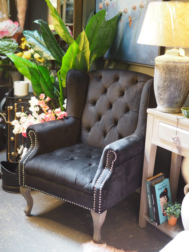 Black button back armchair