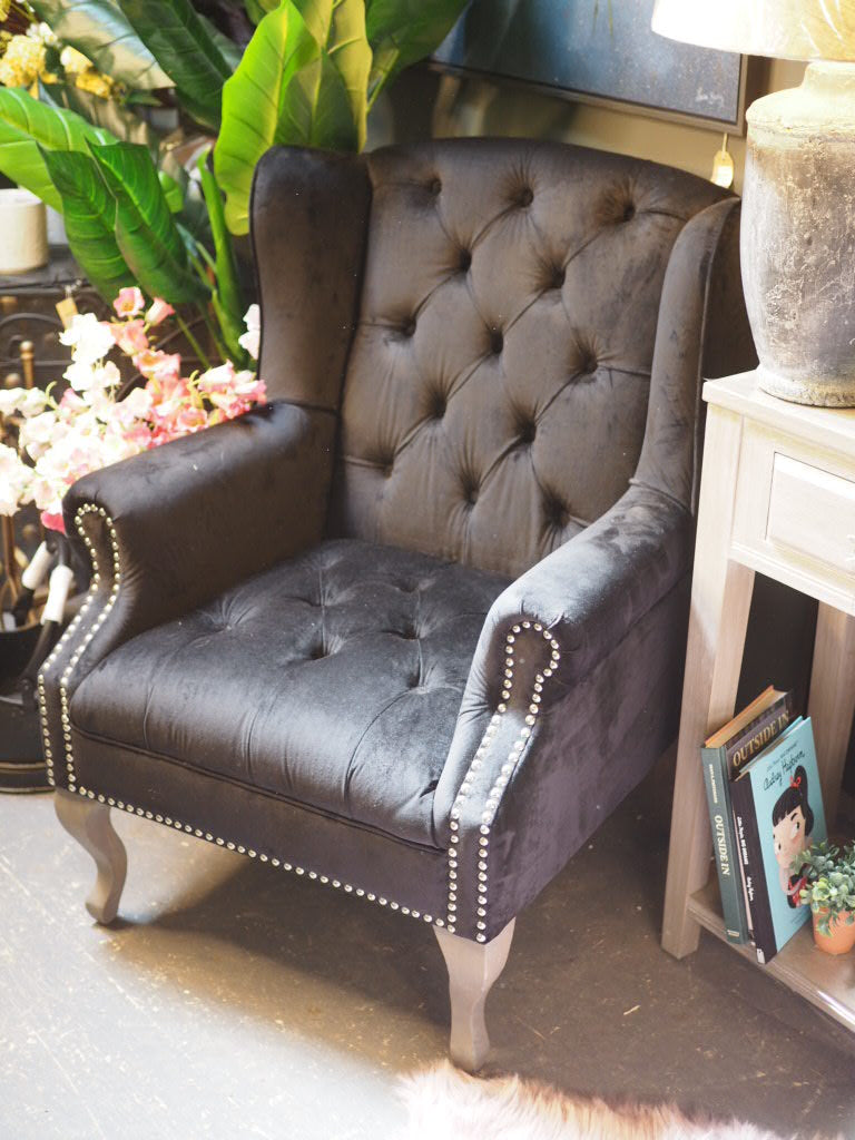 Black button back armchair