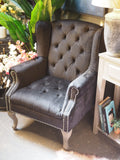 Black button back armchair