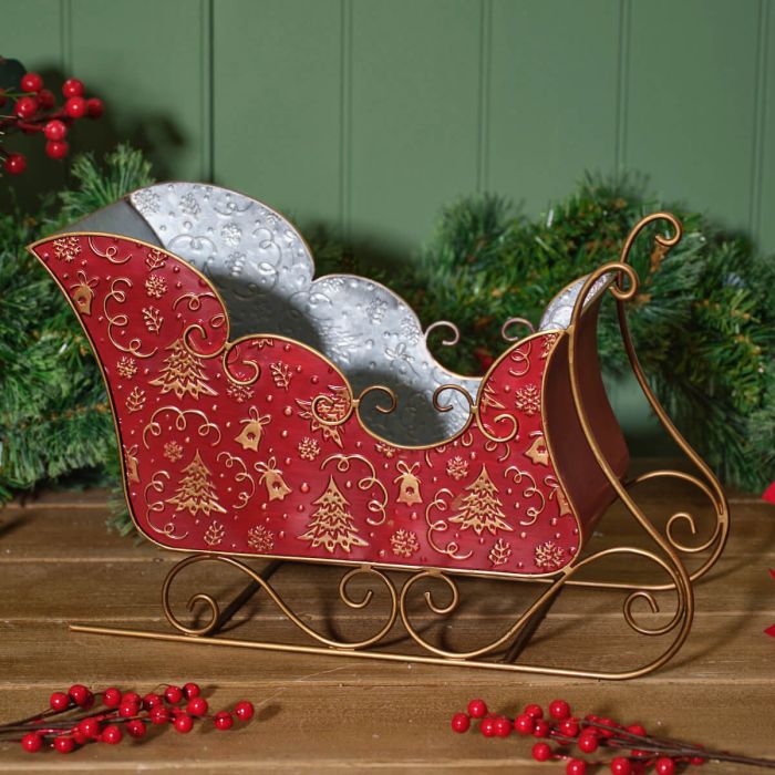 Metal sleigh with embossed Christmas trees and bells