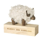 White fluffy & fabulous ram on wooden block