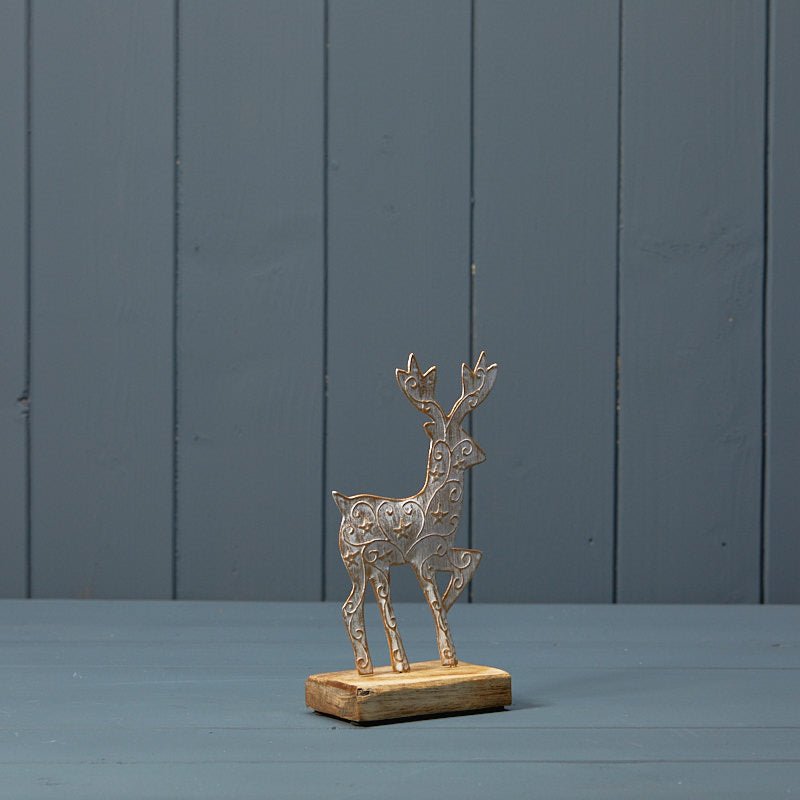 White and gold metal deer on wooden base