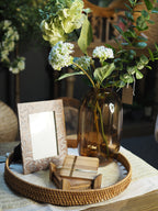 Round rattan tray with capiz detail