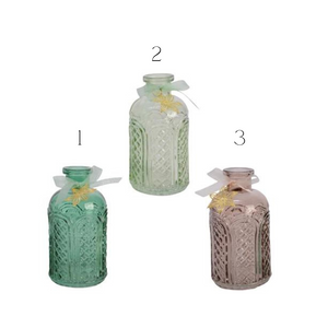 Coloured glass bottles with ribbon and gold flower